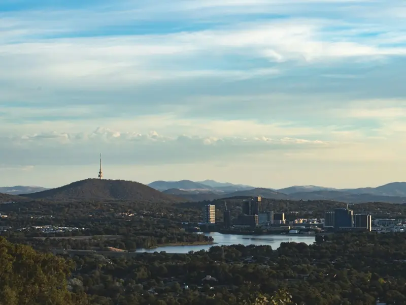 Canberra in late afternoon light, with Black Mountain Tower and the Brindabella Ranges behind.