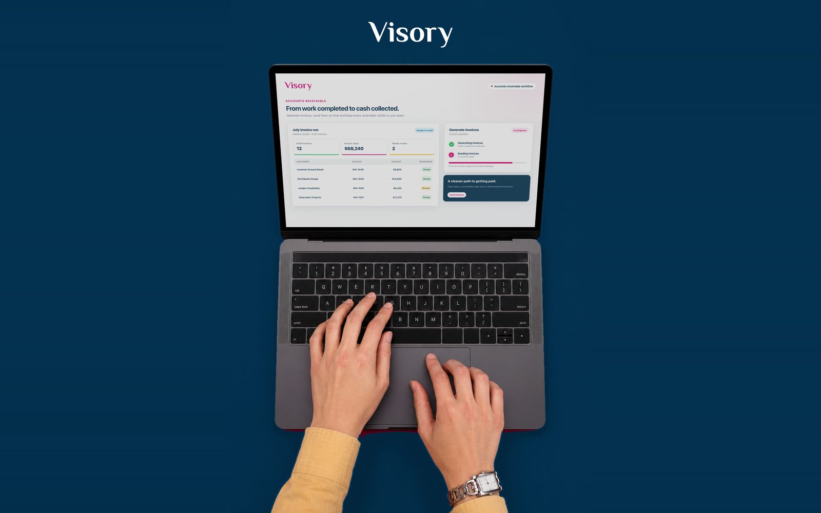 Top-down view of hands on a laptop showing the Visory accounts receivable workflow