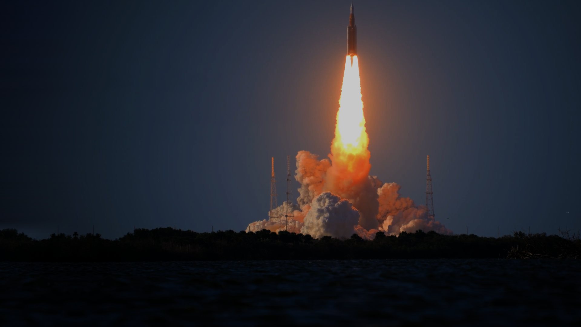 A rocket climbing over the water on a column of flame at dusk, from the Visory recruitment film