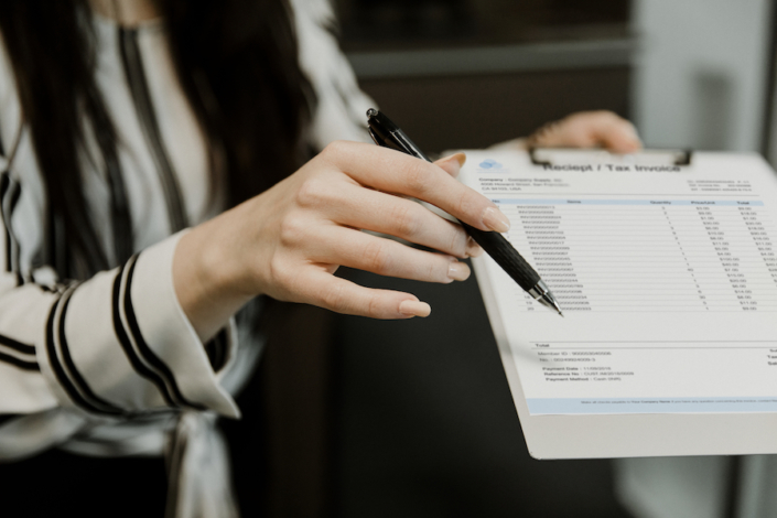 Woman holding accounts payable invoice