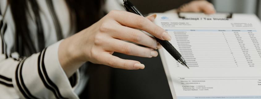 Woman holding accounts payable invoice