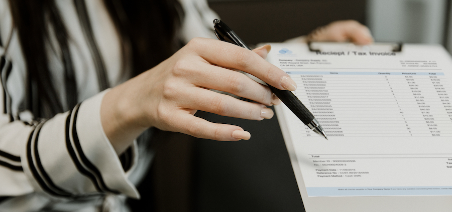 Woman holding accounts payable invoice