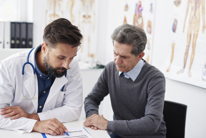 Men working on bookkeeping for a medical practice