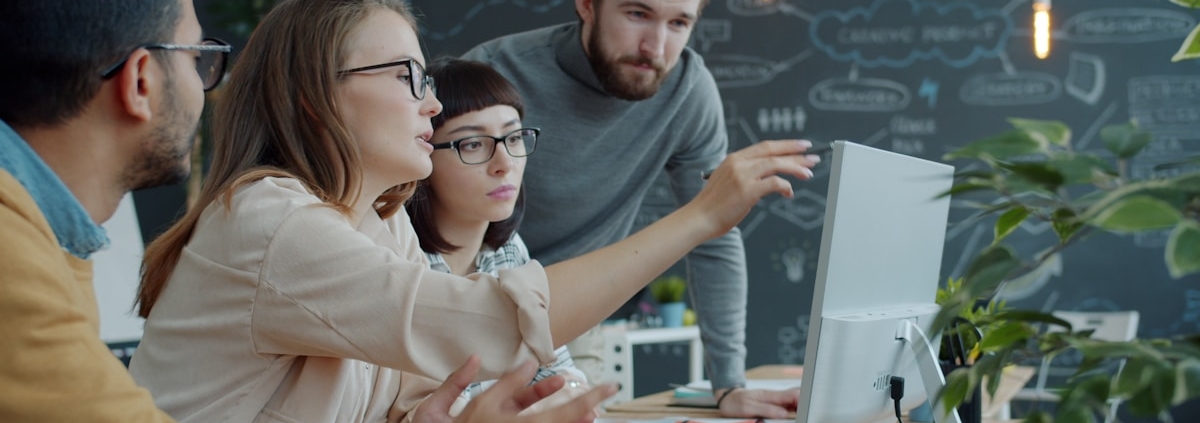 Team reviewing work together on a screen in a studio